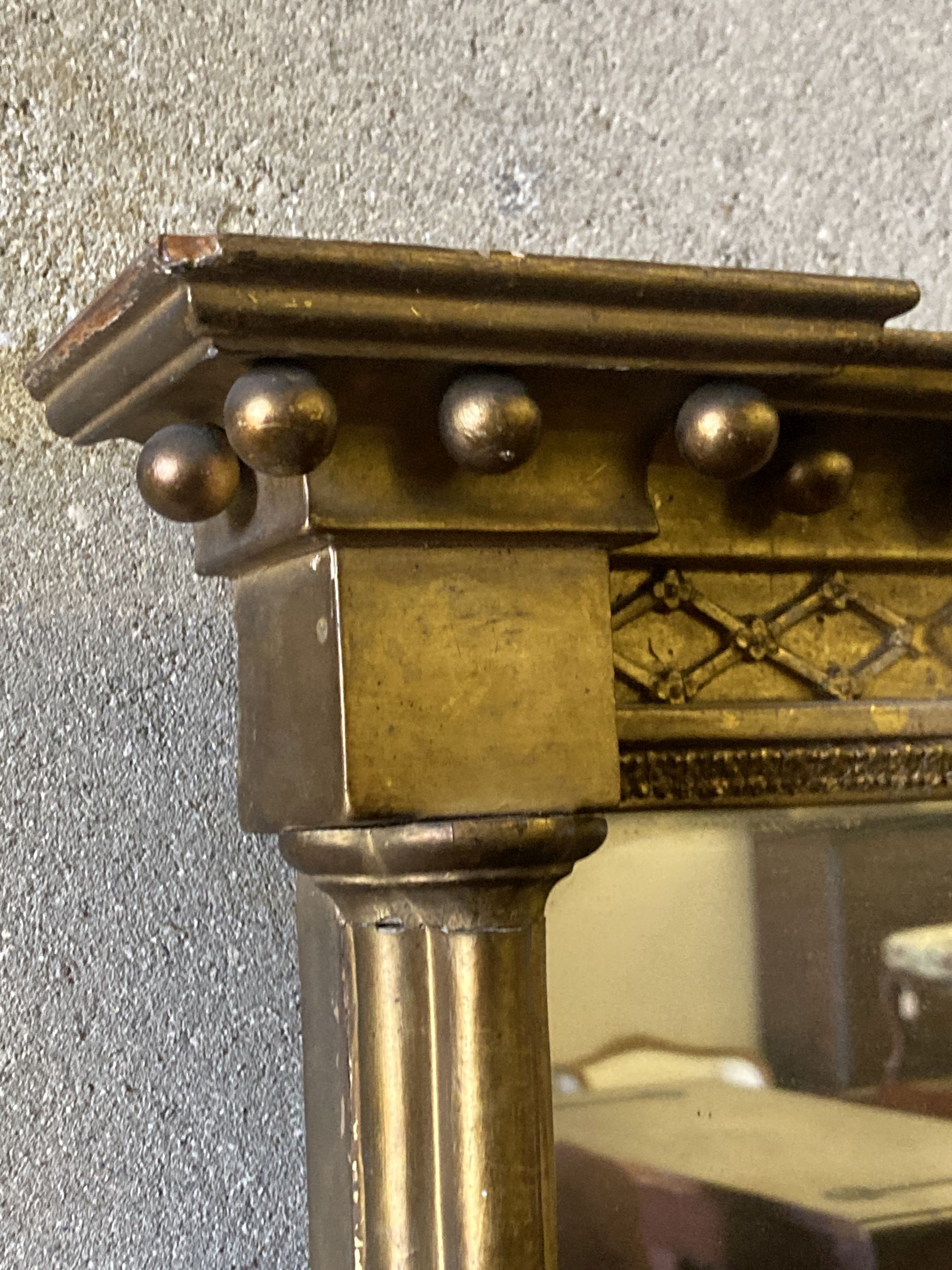 A 19th century rectangular gilt framed wall mirror, with pillar and ball shot frame, width 55cm, height 93cm